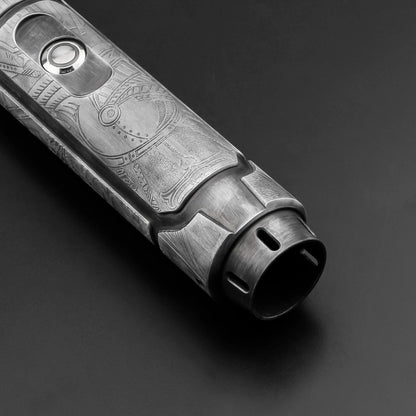 Metallic object with engraved design on a dark background